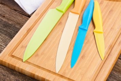 ceramic knives on a wooden cutting board