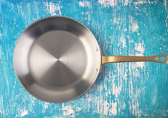 carbon steel pan on blue table